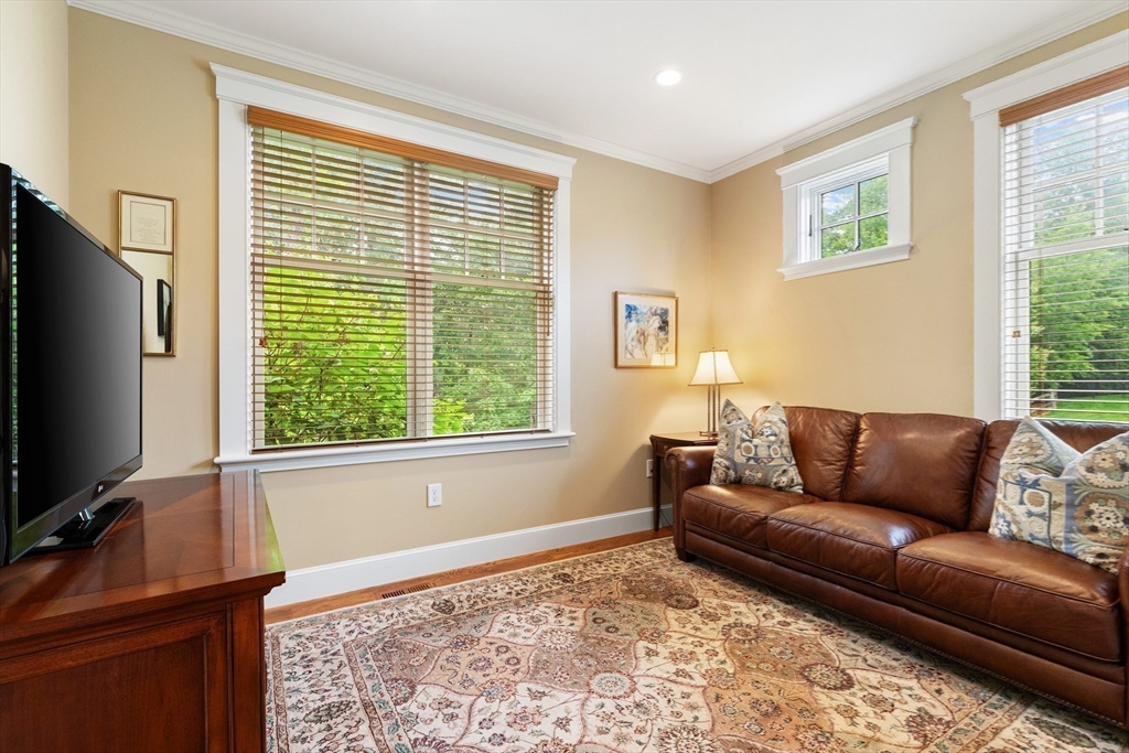 27 Whitehall Circle Beverly, MA 01915 - Photo 19 of 42 a living room with furniture and a flat screen tv