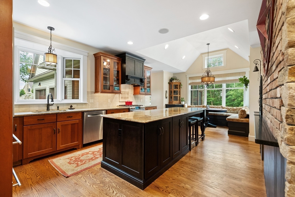 27 Whitehall Circle Beverly, MA 01915 - Photo 5 of 42 a kitchen with a sink stove and wooden cabinets