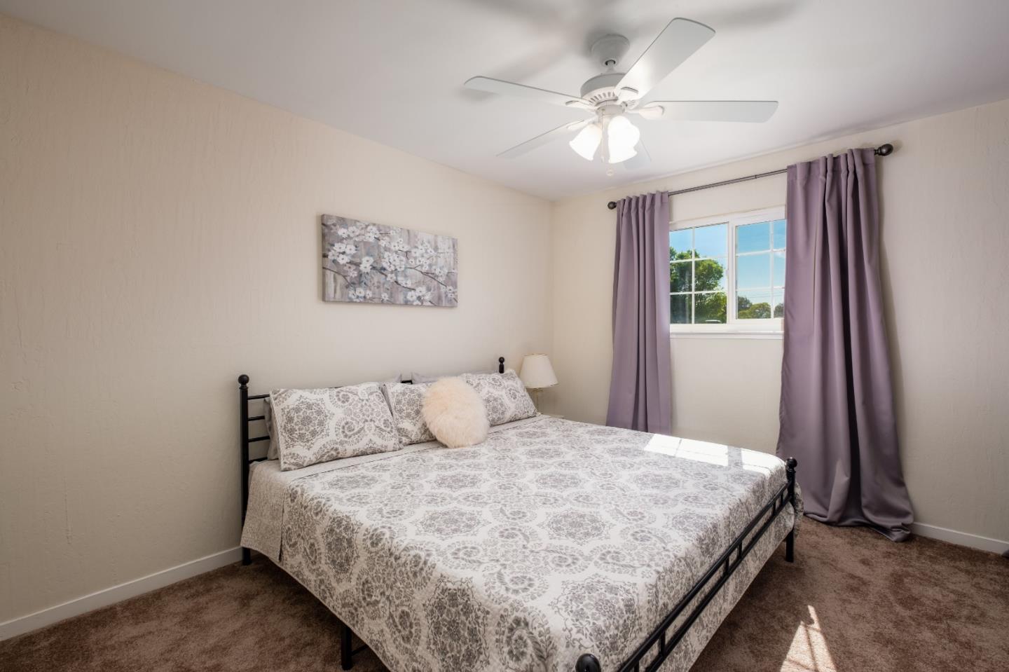 265 Bieber Drive San Jose, CA 95123 - Photo 14 of 28 a bedroom with a large bed and a chandelier