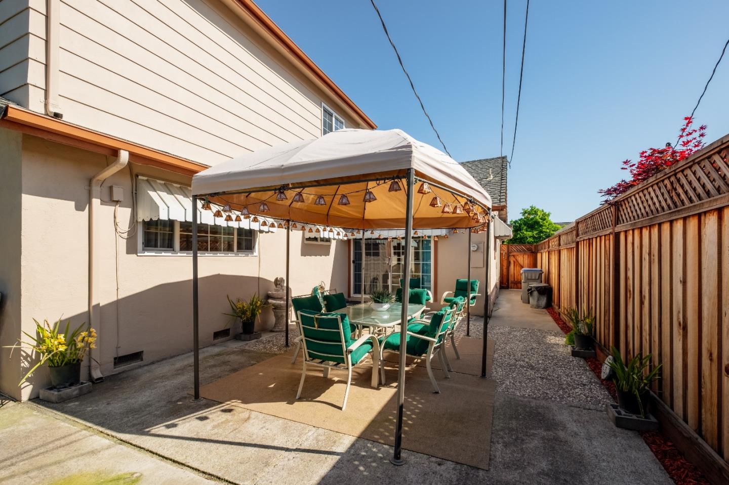 265 Bieber Drive San Jose, CA 95123 - Photo 21 of 28 a view of a patio with table and chairs potted plants and floor to ceiling window