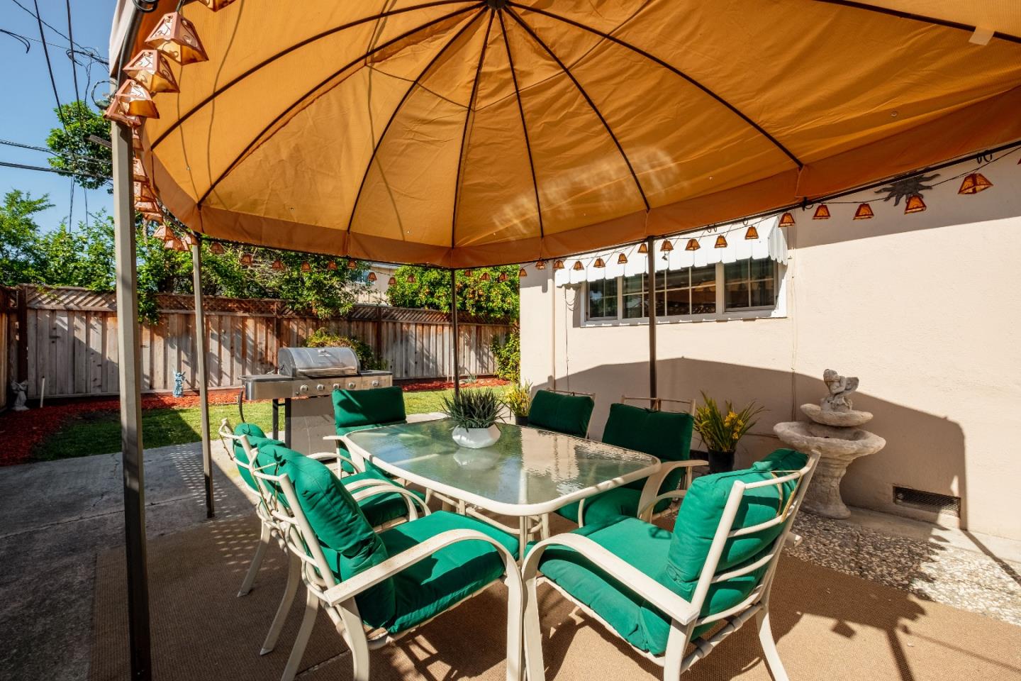 265 Bieber Drive San Jose, CA 95123 - Photo 23 of 28 a patio with a table and chairs under an umbrella