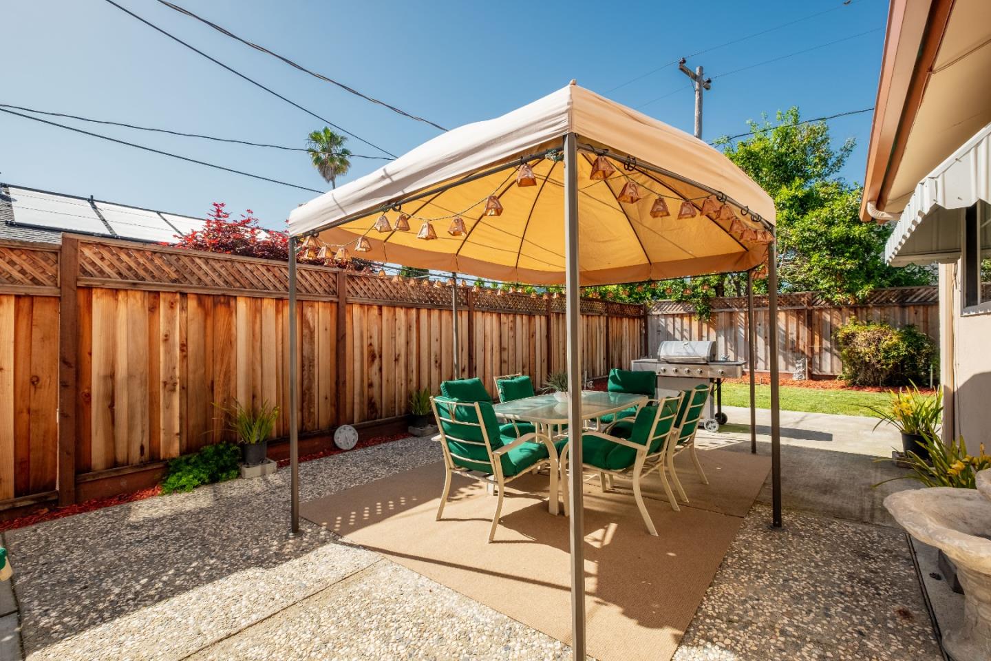 265 Bieber Drive San Jose, CA 95123 - Photo 24 of 28 a view of a patio with table and chairs under an umbrella