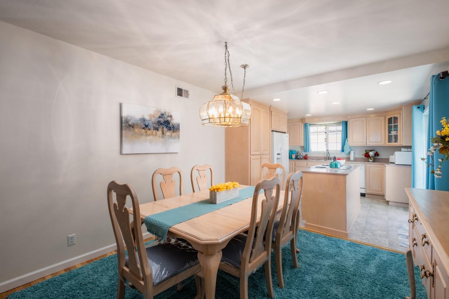 265 Bieber Drive San Jose, CA 95123 - Photo 7 of 28 a dining room with furniture a chandelier and kitchen view