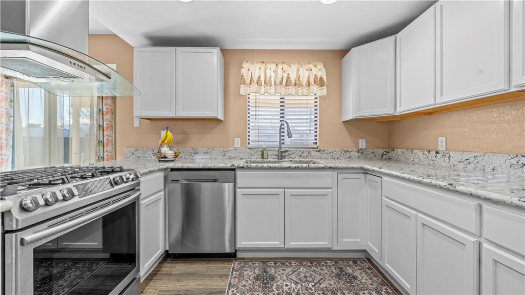 11639 Pagosi Road Apple Valley, CA 92308 - Photo 12 of 37 a kitchen with granite countertop a stove sink and cabinets