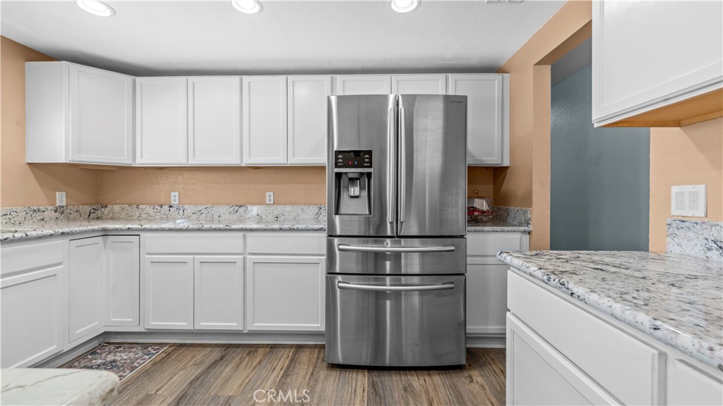 11639 Pagosi Road Apple Valley, CA 92308 - Photo 13 of 37 a kitchen with granite countertop white cabinets and stainless steel appliances