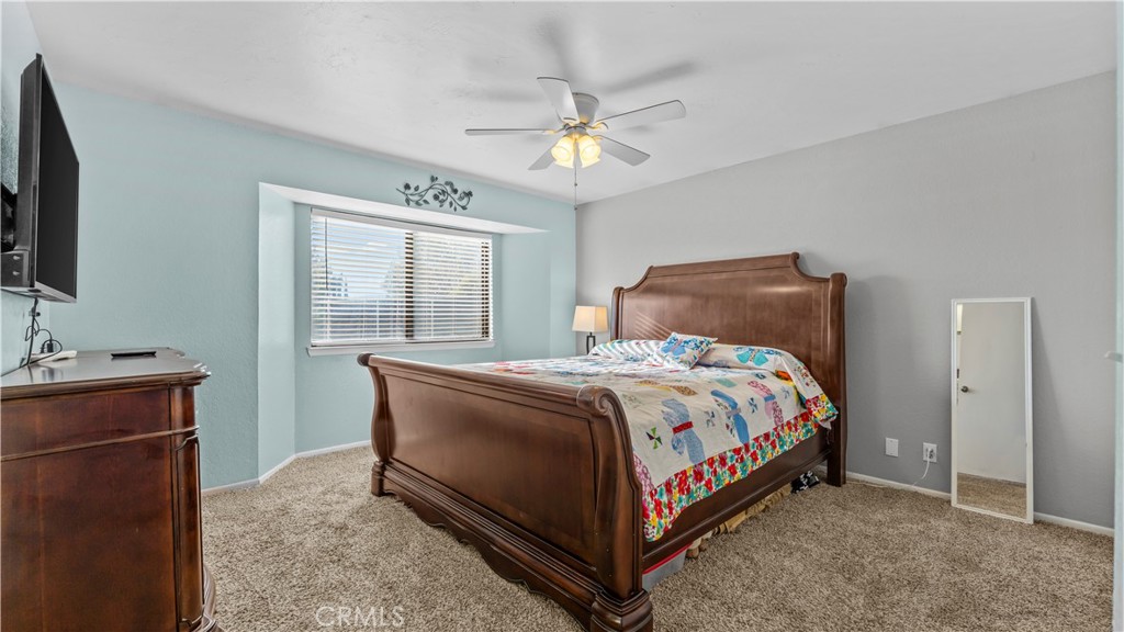 11639 Pagosi Road Apple Valley, CA 92308 - Photo 16 of 37 a bed sitting in a bedroom next to a window