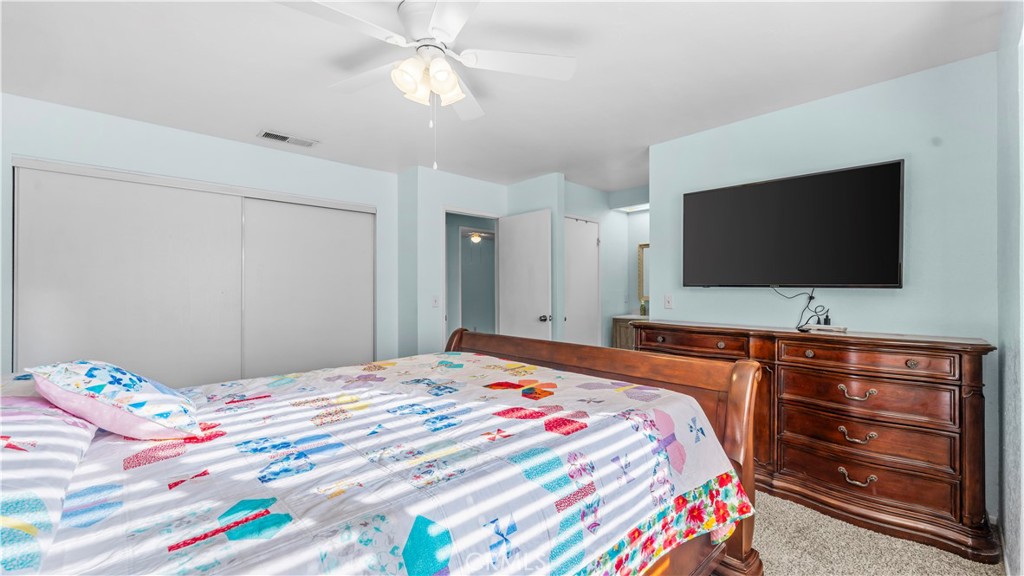 11639 Pagosi Road Apple Valley, CA 92308 - Photo 17 of 37 a bedroom with a bed and a flat screen tv in it