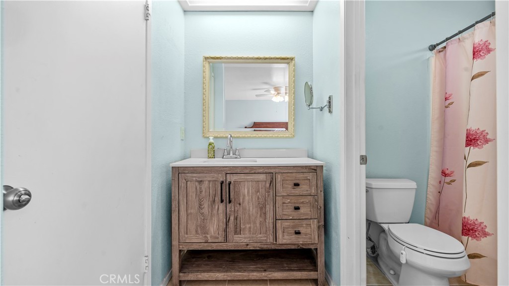 11639 Pagosi Road Apple Valley, CA 92308 - Photo 18 of 37 a bathroom with a sink a toilet and a mirror