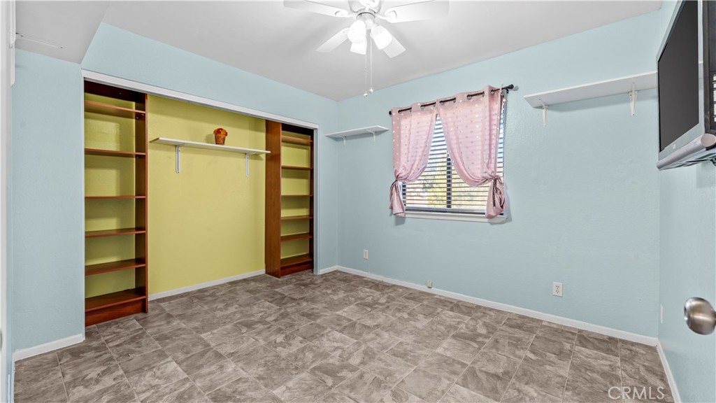 11639 Pagosi Road Apple Valley, CA 92308 - Photo 19 of 37 a view of empty room with window and ceiling fan