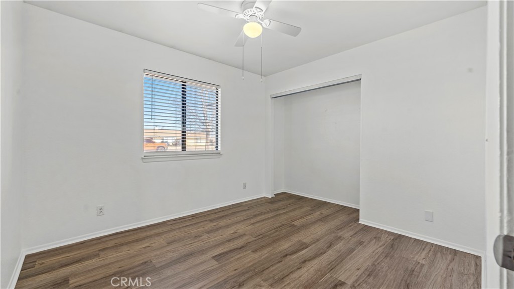 11639 Pagosi Road Apple Valley, CA 92308 - Photo 20 of 37 an empty room with wooden floor and windows