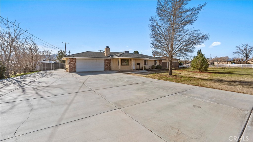 11639 Pagosi Road Apple Valley, CA 92308 - Photo 3 of 37 a view of a house with a yard and trees