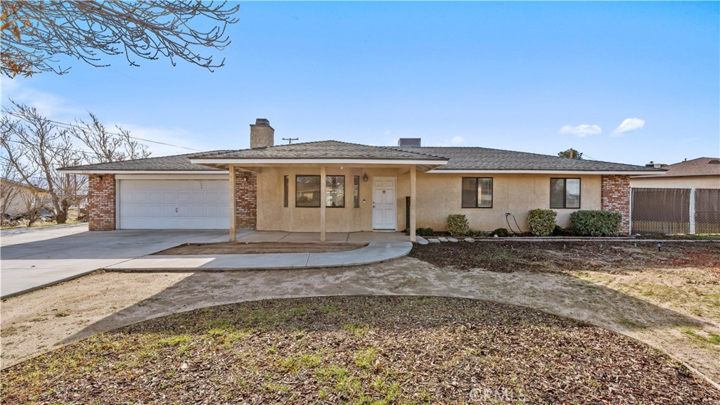 11639 Pagosi Road Apple Valley, CA 92308 - Photo 36 of 37 a front view of a house with a yard