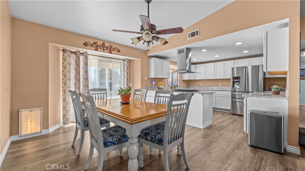 11639 Pagosi Road Apple Valley, CA 92308 - Photo 9 of 37 a view of a dining room with furniture window and wooden floor
