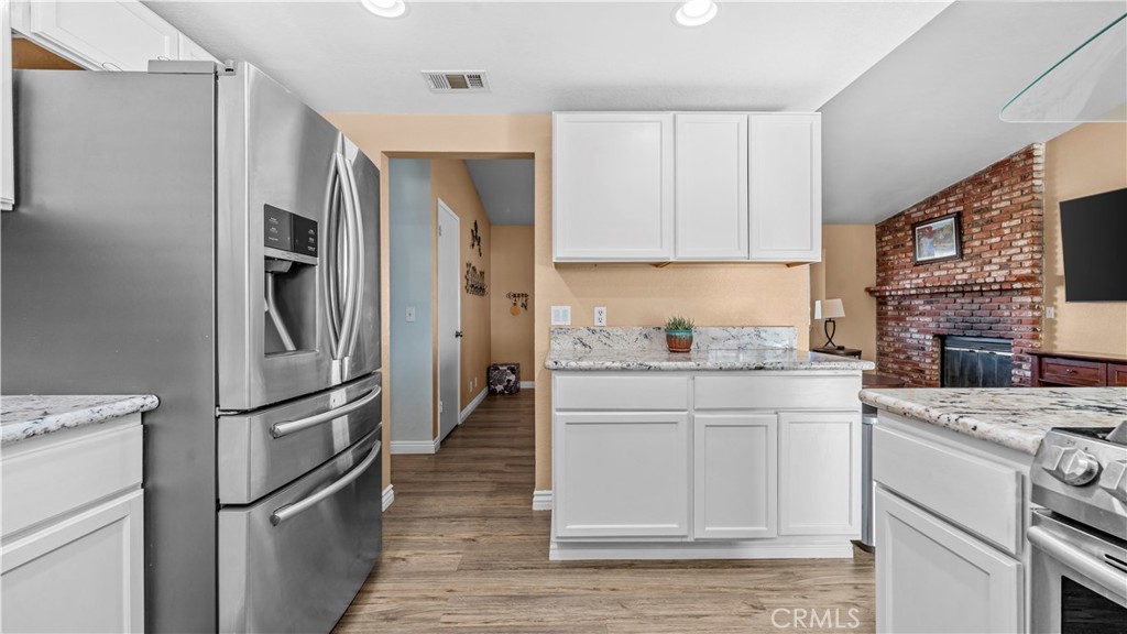 11639 Pagosi Road Apple Valley, CA 92308 - Photo 10 of 37 a kitchen with stainless steel appliances granite countertop a refrigerator sink and stove