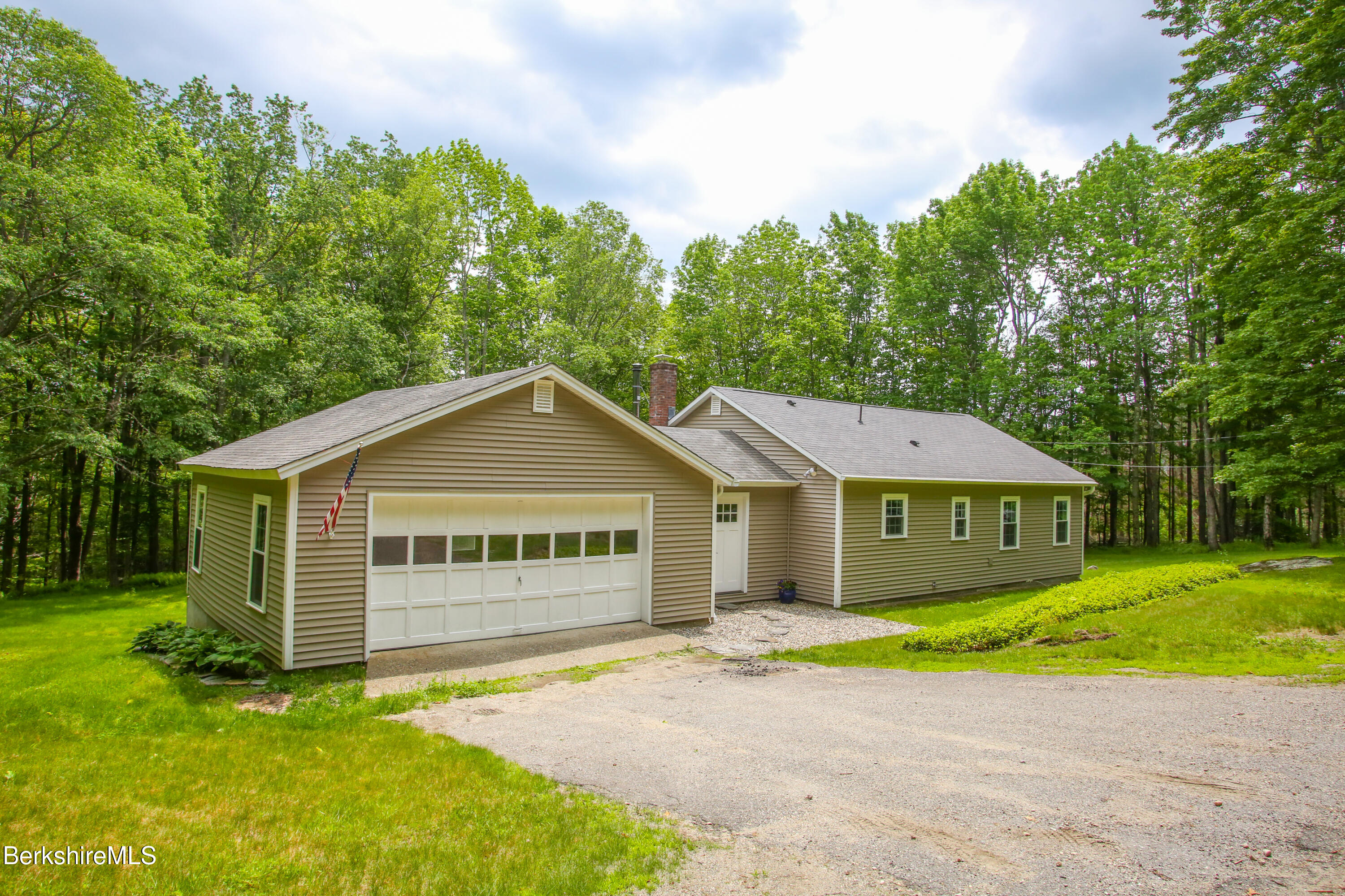 127 County Road Rowe, MA 01367 - Photo 1 of 29 a front view of a house with a garden and yard