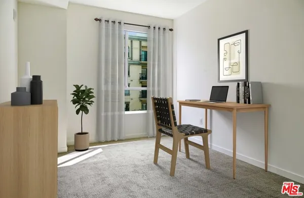a living room with furniture a flat screen tv and kitchen view