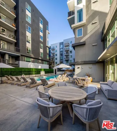 a outdoor space with patio couch and a fire pit