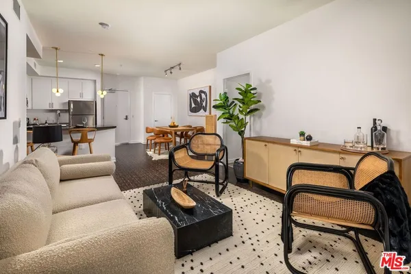 a living room with furniture a table and a potted plant