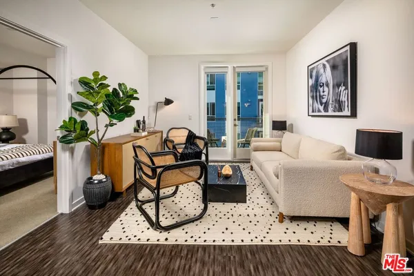 a kitchen with stainless steel appliances granite countertop a sink a stove a dining table and chairs