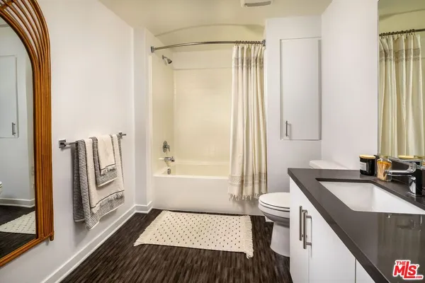 a bed room with a bed and a mirror