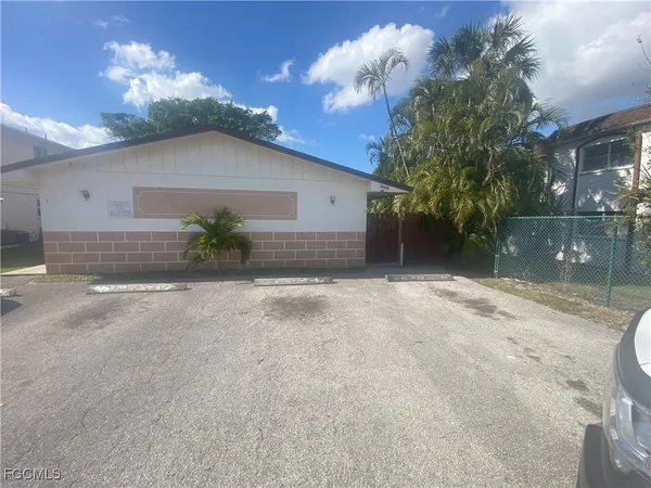 a view of a house with a yard and a garage