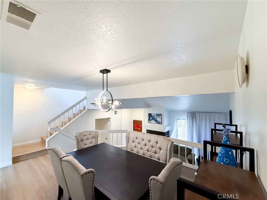 33 Wildflower Place Phillips Ranch, CA 91766 - Photo 15 of 49 a living room with kitchen island furniture and a chandelier