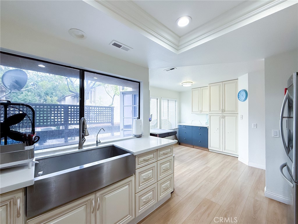 33 Wildflower Place Phillips Ranch, CA 91766 - Photo 20 of 49 a large kitchen with stainless steel appliances granite countertop a sink dishwasher a refrigerator and a dining table with wooden floor