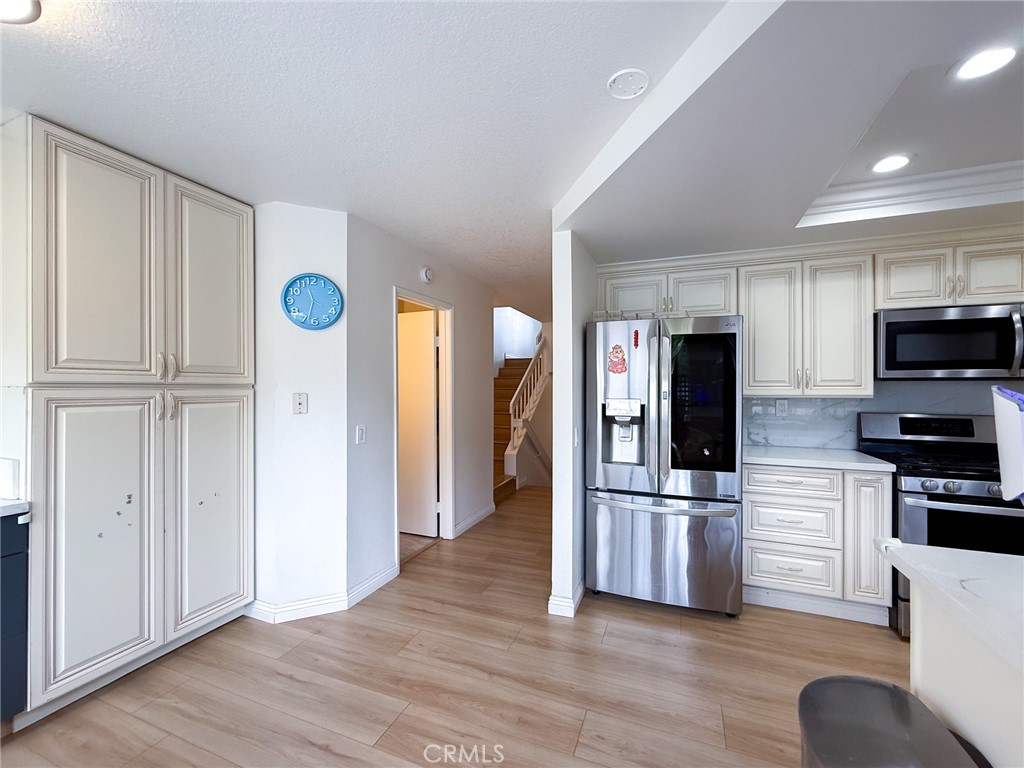 33 Wildflower Place Phillips Ranch, CA 91766 - Photo 22 of 49 a view of kitchen with stainless steel appliances granite countertop a refrigerator and a stove top oven