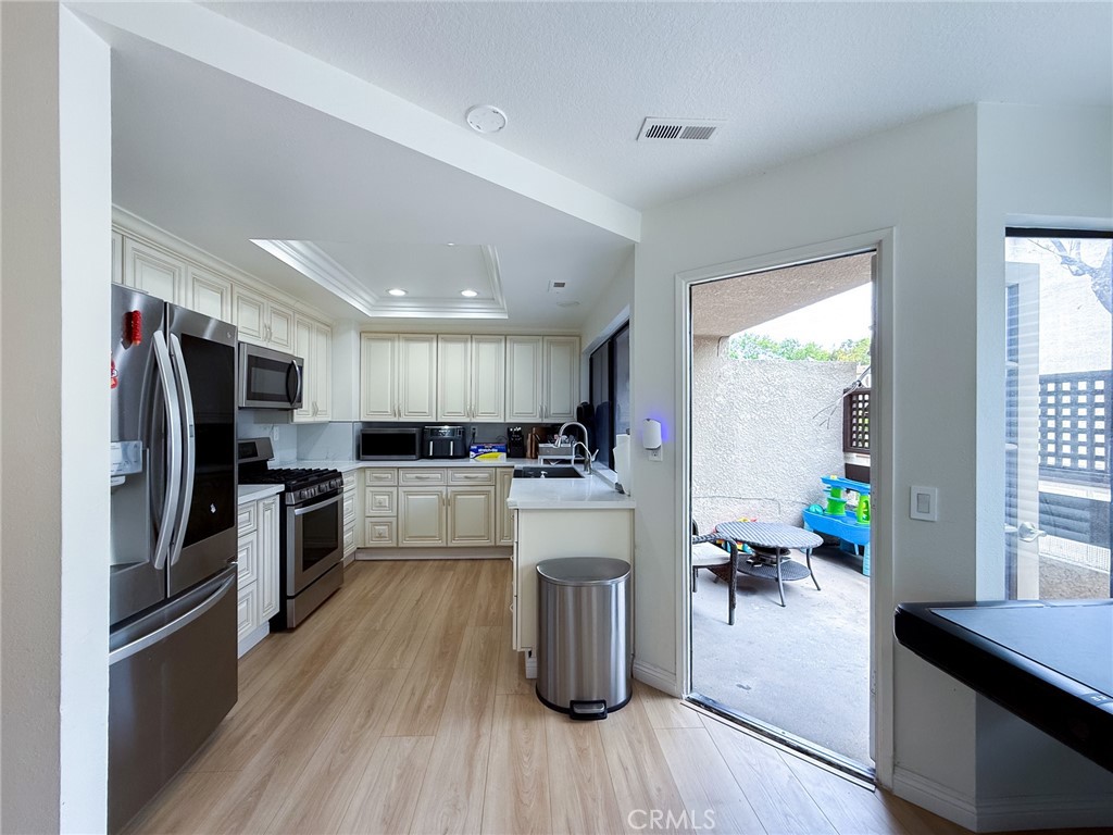 33 Wildflower Place Phillips Ranch, CA 91766 - Photo 23 of 49 a kitchen with a refrigerator and a stove top oven