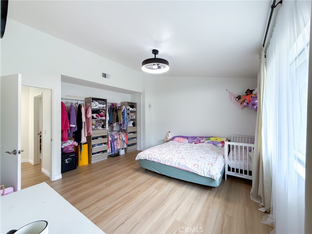 33 Wildflower Place Phillips Ranch, CA 91766 - Photo 29 of 49 a bedroom with a bed and a walk in closet