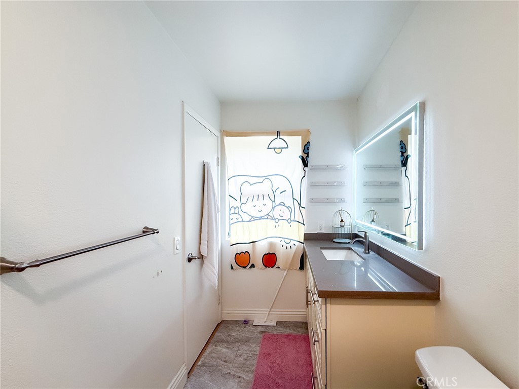 33 Wildflower Place Phillips Ranch, CA 91766 - Photo 30 of 49 a white bath tub sitting next to a white sink and vanity