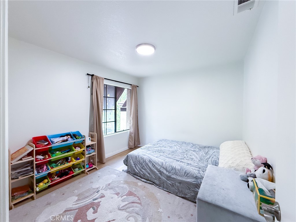 33 Wildflower Place Phillips Ranch, CA 91766 - Photo 32 of 49 a bedroom with a bed and a window