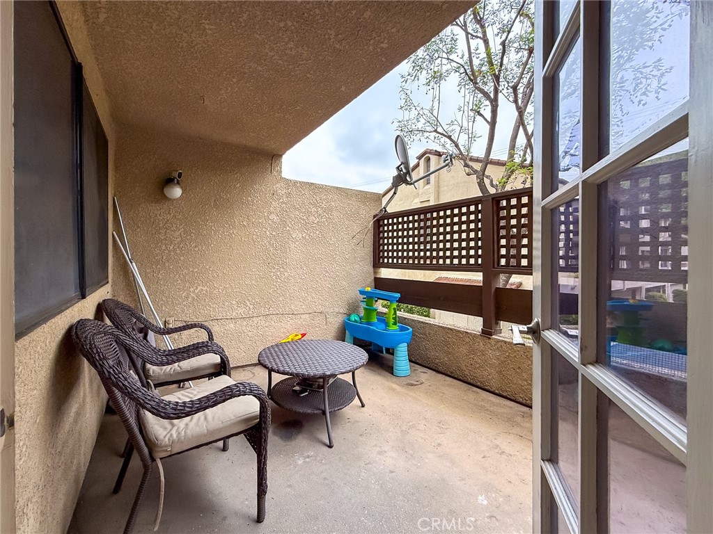 33 Wildflower Place Phillips Ranch, CA 91766 - Photo 38 of 49 a balcony with a bench and some potted plants