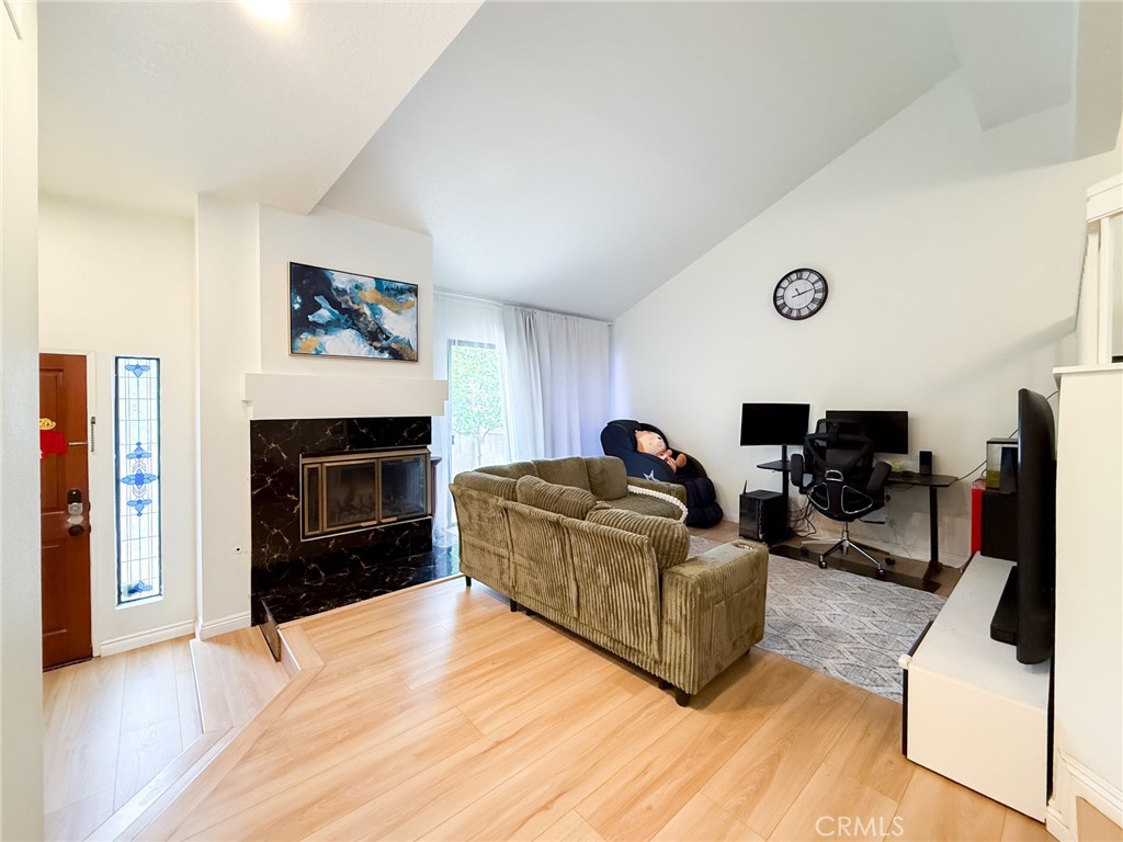 33 Wildflower Place Phillips Ranch, CA 91766 - Photo 6 of 49 a living room with furniture a flat screen tv and a fireplace