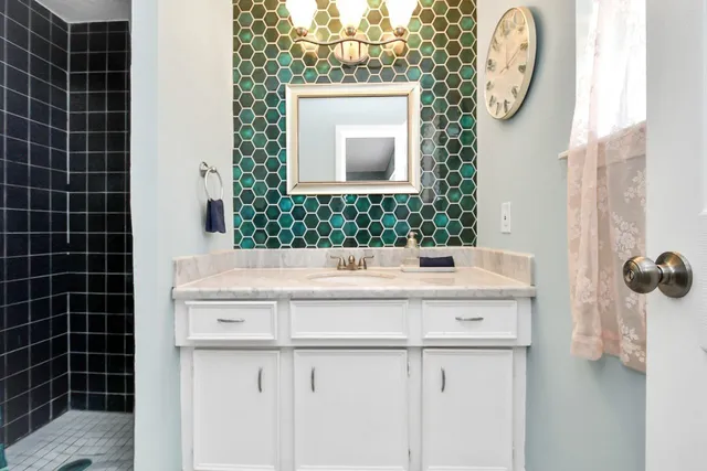 a bathroom with a sink a vanity and a mirror