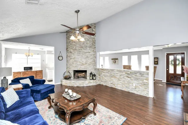 a living room with furniture and a fireplace
