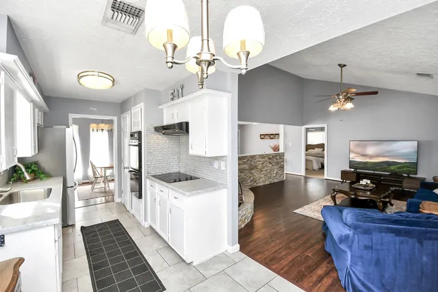 a kitchen with a sink stove and refrigerator