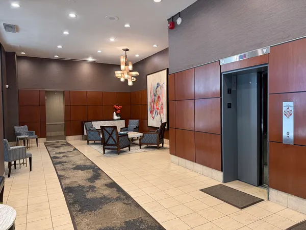 a lobby with furniture and a potted plant