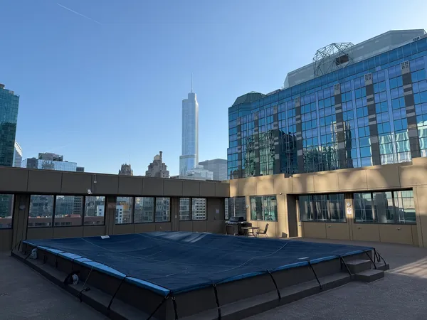 a view of a roof deck with couple of couches
