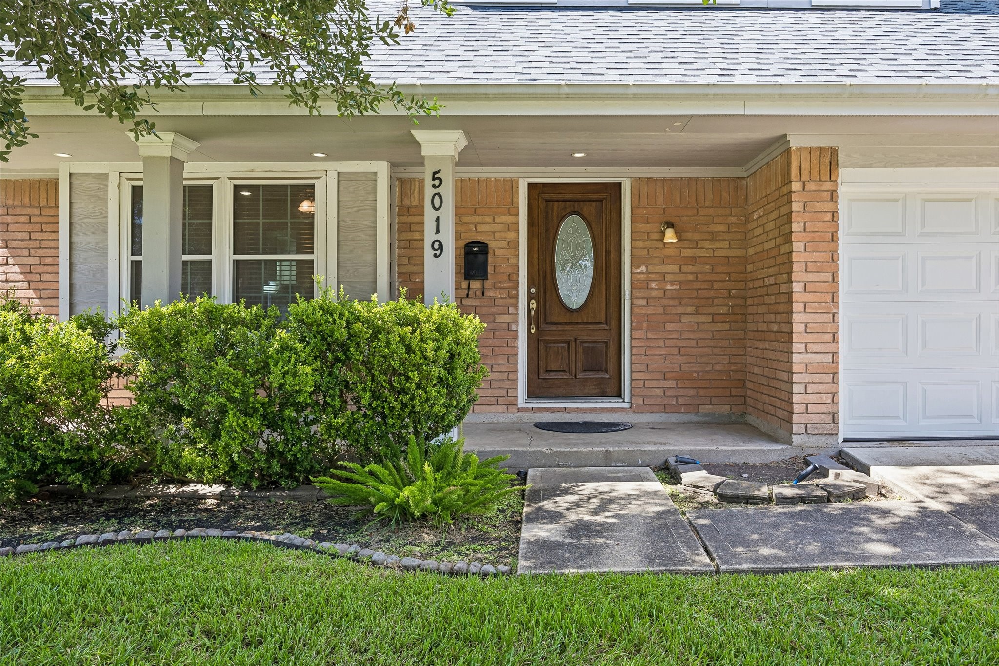 5019 Kinglet Street Houston, TX 77035 - Photo 2 of 24 Entrance is graced by stained wood door, upgraded windows & lovely landscaping! Beautiful mature tree offers abundant shade!