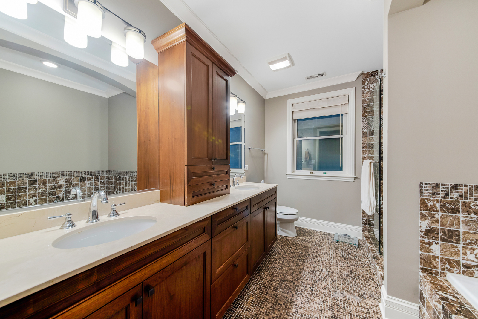 1238 West Jackson Boulevard, Unit 2W Chicago, IL 60607 - Photo 5 of 12 a bathroom with a double vanity sink and a mirror