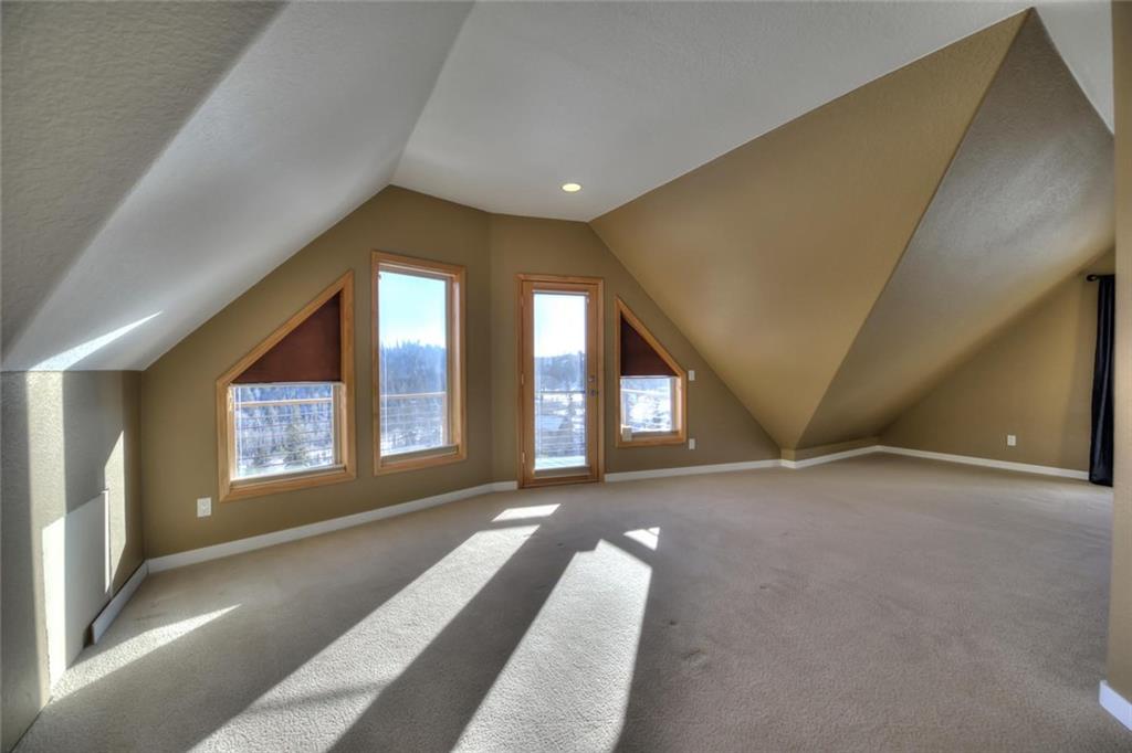 138 Teton Way Como, CO 80432 - Photo 12 of 35 a view of an empty room with a fireplace and windows