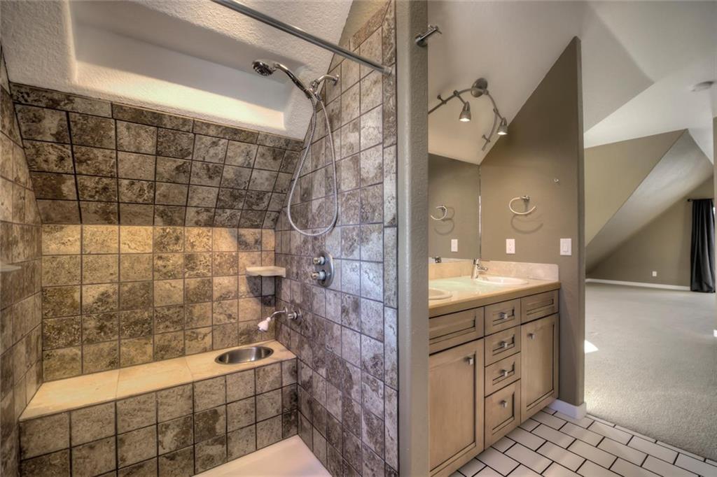 138 Teton Way Como, CO 80432 - Photo 15 of 35 a bathroom with a granite countertop sink a toilet and shower