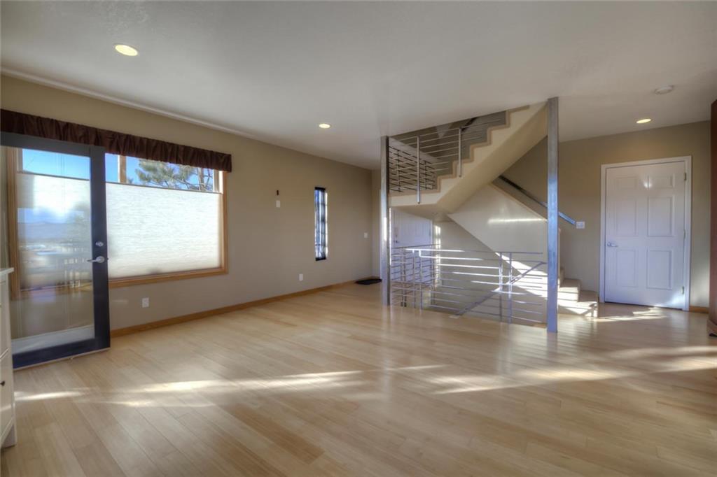 138 Teton Way Como, CO 80432 - Photo 19 of 35 an empty room with windows and stairs