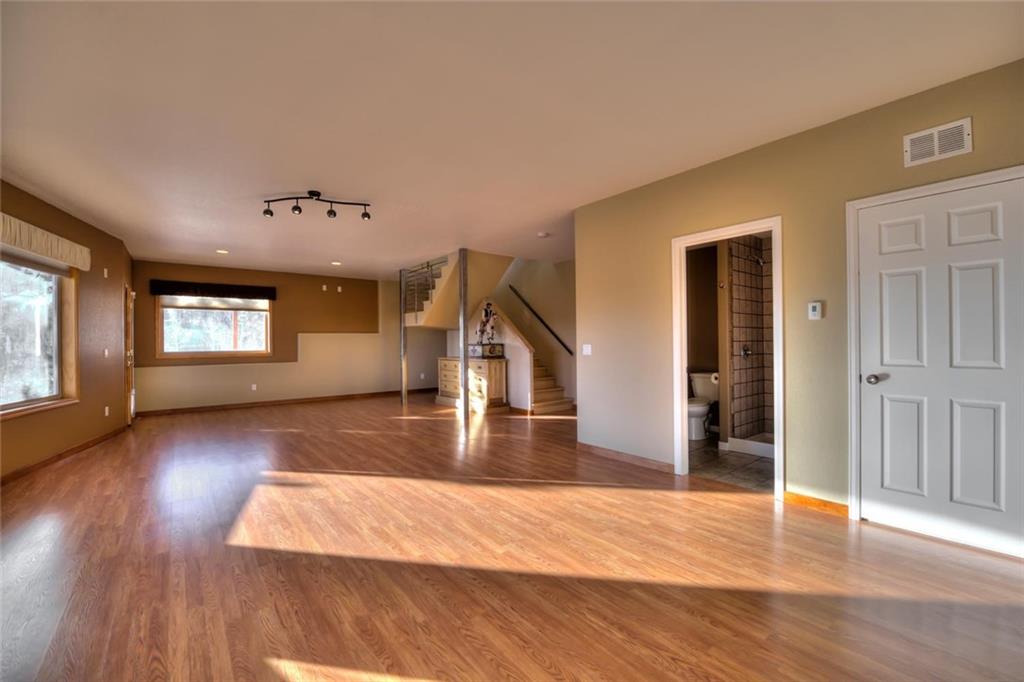 138 Teton Way Como, CO 80432 - Photo 20 of 35 a view of an empty room with wooden floor and a window