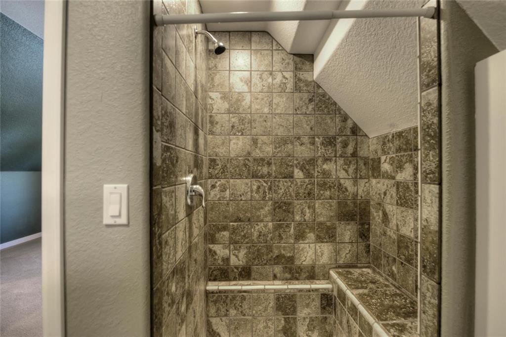 138 Teton Way Como, CO 80432 - Photo 24 of 35 a bathroom with a glass shower door