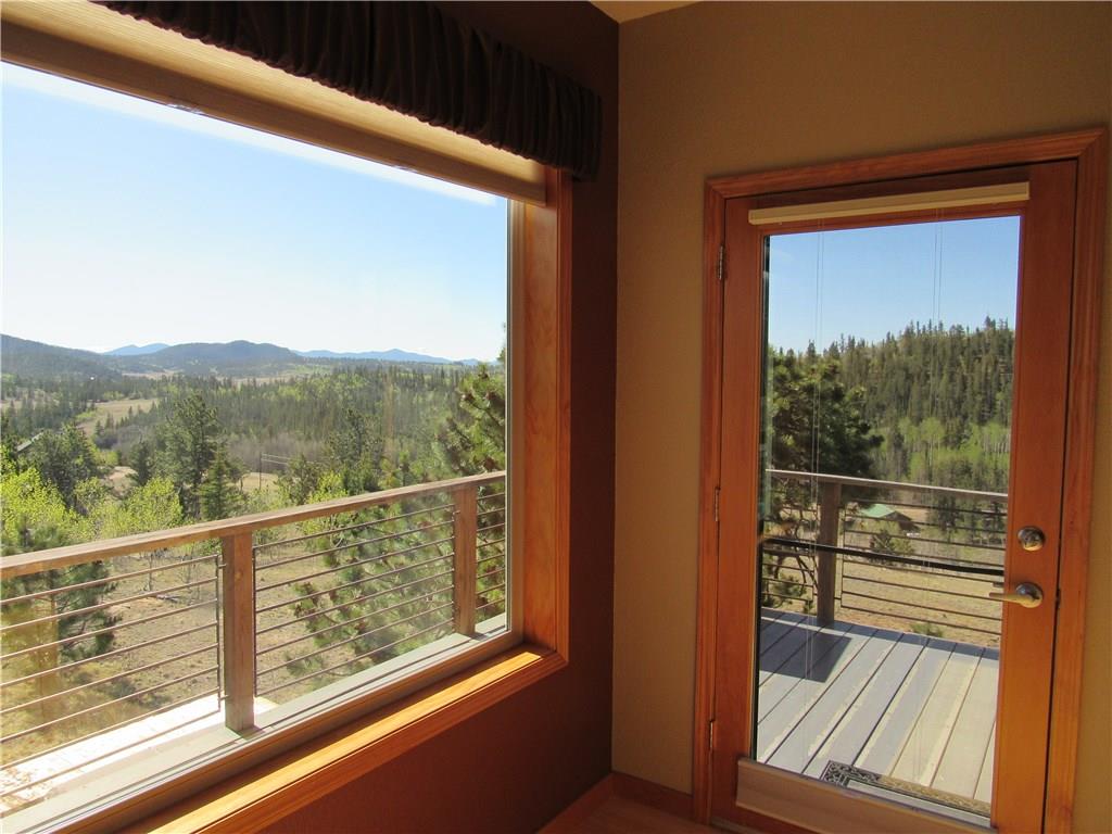 138 Teton Way Como, CO 80432 - Photo 7 of 35 a view of a room with wooden floor and iron stairs
