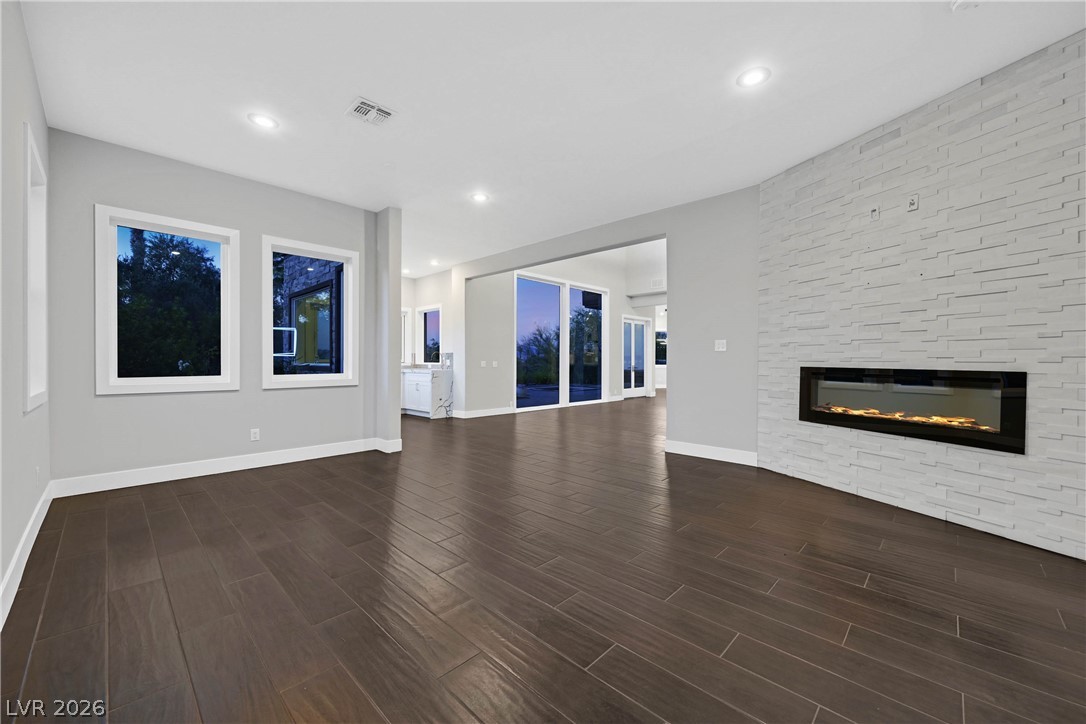 6 Rue Du Ville Henderson, NV 89011 - Photo 48 of 99 This expansive interior features dark flooring and an inviting fireplace, perfect for gatherings.