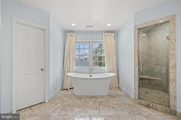 a bathroom with a bathtub and shower