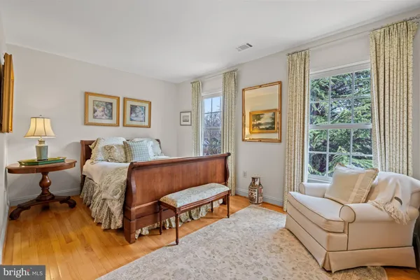 a bedroom with furniture and a large window